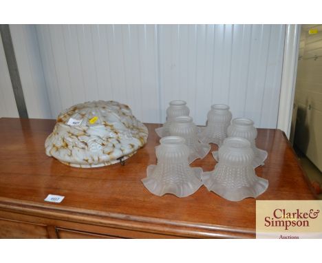 A mottled glass light shade and six opaque glass light shades
