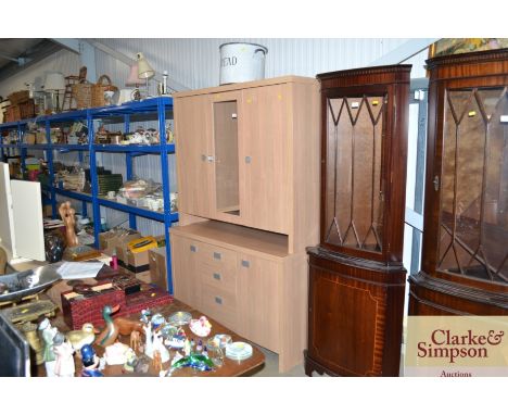 A modern light wood effect and glazed display cabinet on cupboard base