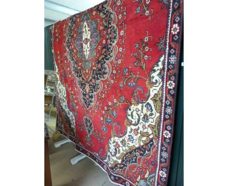 Red Ground persian tabriz carpet with floral medallion design.