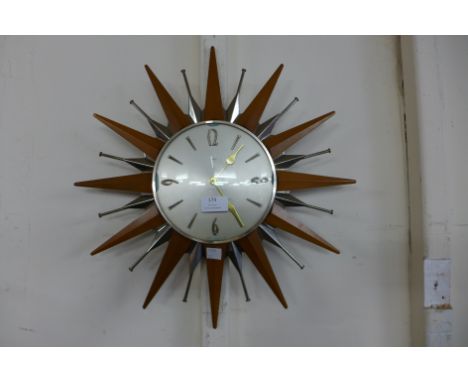 A Metamec sunburst teak  wall clock 