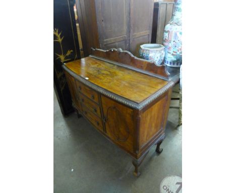 A walnut bow front sideboard 