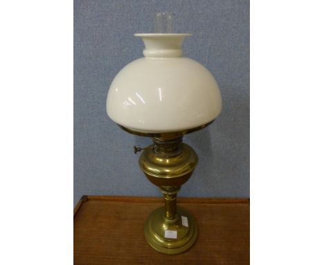 A brass oil lamp with white glass shade 