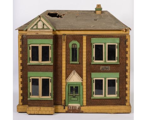 A large early 20th century dolls house, with opening double front and back, containing hallway staircase and landing, four gr