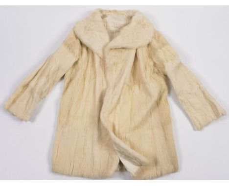 A vintage white fur half length coat:.