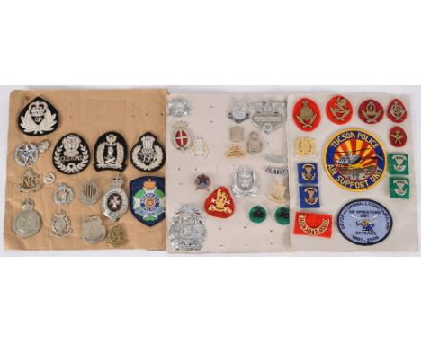 A collection of assorted Police and Customs cloth and cap badges:, includes Tucson Police, St Vincent Police, Rotterdam Polic