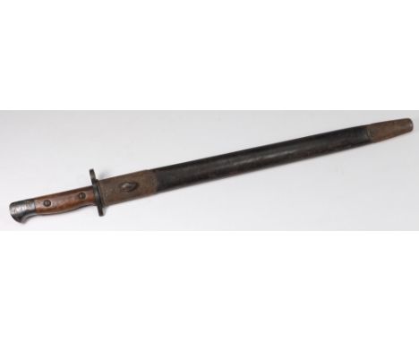 A World War I British bayonet: with 43cm. fullered blade, wood grip and contained in a leather scabbard.
