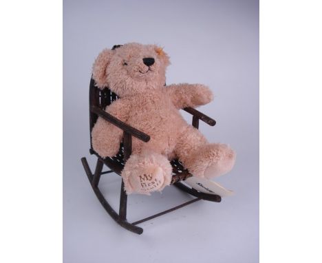 A Steiff brown plush 'My First Steiff' Teddy in a rocking chair:.