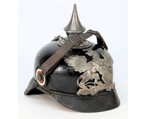 An Imperial Germany Army pickelhaube, with Baden wappen:, black leather skull with spike, vented rear spine and rosettes, lea