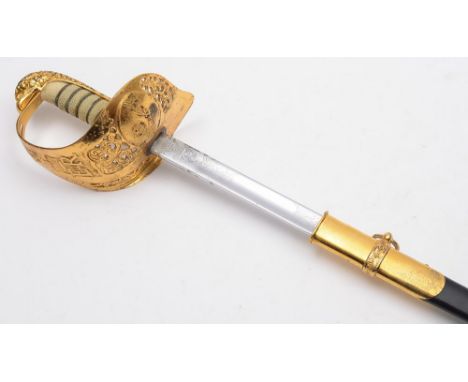 An R.A.F. Officer's dress sword: with 83cm. fullered and etched blade with RAF cypher, gilt brass knuckleguard with pierced f