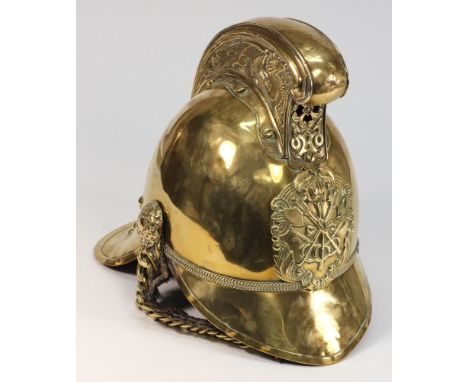 An Edwardian brass Merryweather pattern  Fireman's helmet:, the front plate with crossed axes, embossed dragon comb, embossed