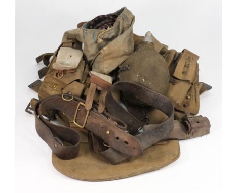 A World War II German army belt:, a British Sam Browne belt and assorted canvas webbing, water bottle, etc.
