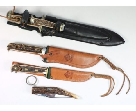 Four Puma antler handled hunting knives in leather scabbards, and a French folding knife:. 