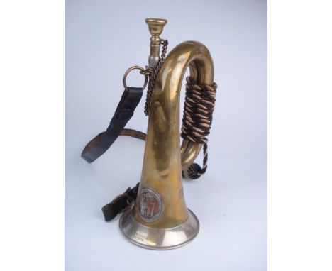 A WWII German Third Reich period brass bugle, by Meinel & Herold, Klingenthal:, with silvered mount to bell and circular SS b