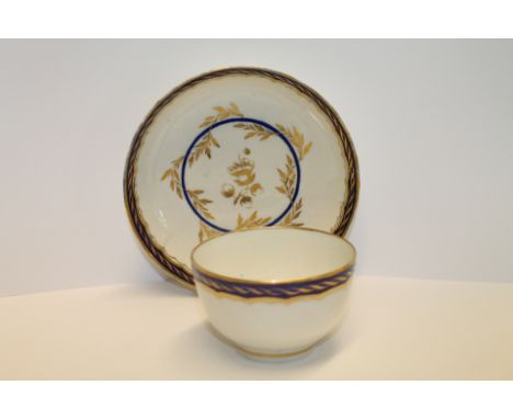 Worcester, Flight period, tea bowl of plain circular form with saucer, characteristic blue & gilt rim, other gilt & blue foli
