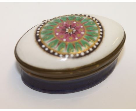 18th century English enamel oval patch box, the hinged mirrored cover with geometric circular design above blue base, 5cm wid
