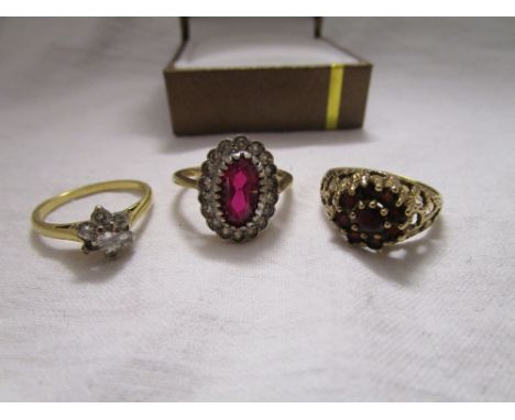 3 stone set gold rings to include 1 18ct.The daisy cluster is the 18ct & has a missing stone. The sizes are as follows: Red/p