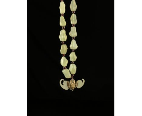 A 20th century Chinese necklace having a series of naturalistic light green jade beads with a silver clasp and a stylised sil