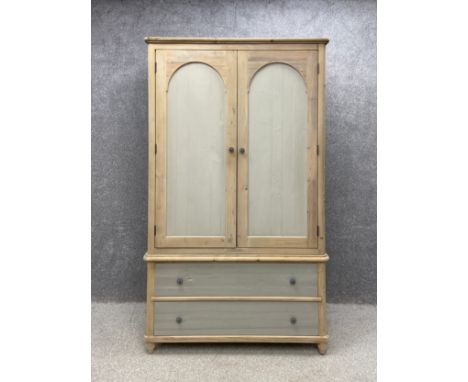 A contemporary lime-washed and painted ash wardrobe in the French provincial 19th century style having a moulded cornice abov