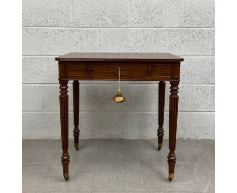 An early 19th century mahogany writing desk having a rectangular top with a secret compartment and reeded edge over a long co