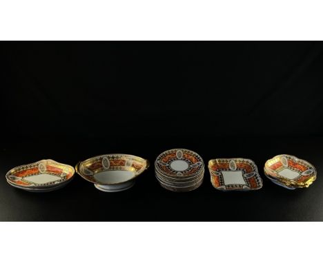 A 19th century porcelain part dinner service with bands of hand painted scrolling gilt foliate decoration over a scarlet grou