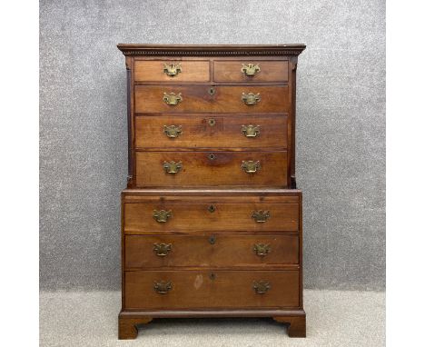 A Georgian mahogany chest on chest having a dentil moulded cornice above two short over three long oak lined drawers flanked 