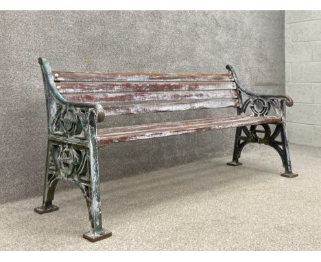 A heavy painted cast iron bench with distressed teak slats by Furnitube dated 1994. H.84 W.168 D.61cm