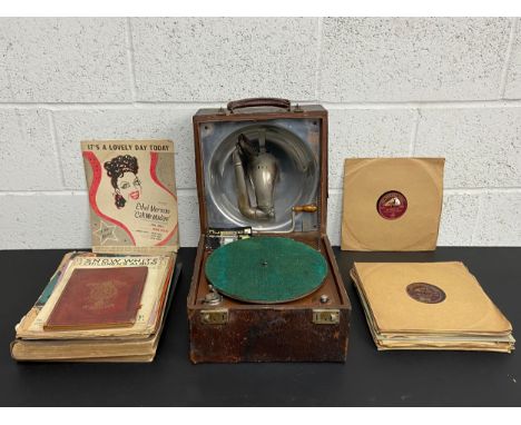 A collection of early 20th century score sheets, 78's or Shellac records, and a working portable gramophone possibly Decca wi