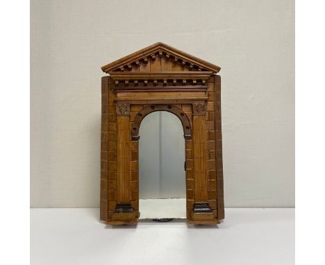 A 20th century wall hanging mirror having a to-scale architectural model archway frame with a dentil moulded pediment and fri