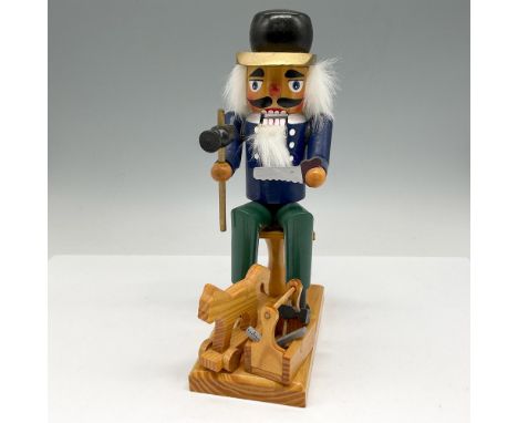 Holding his hammer, saw and box of tools alongside the pull horse made. Colored in black hat, blue shirt and green pants. Mad