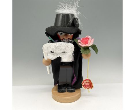 Nutcracker designed with black hat, black cape, holding the mask and a rose. Steinbach impressed mark. S1877. This item has i