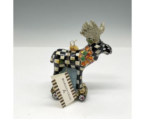 Glitter horned figure designed with signature checker design standing on a skateboard (?!), wearing a holiday red and green c