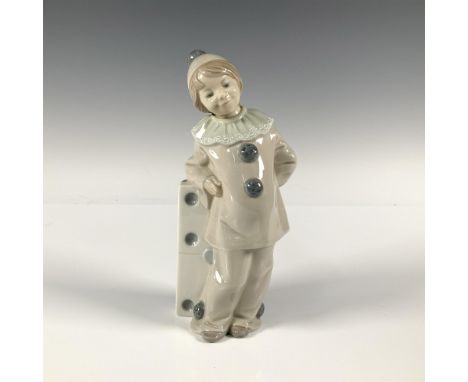 Glossy figure of a girl in a clown outfit, leaning on a big domino piece. Lladro backstamp. This item has its original box: 1