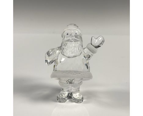 A clear crystal figure depicting Santa Clause with frosted crystal used for his head and the trim of his outfit. Swarovski ba
