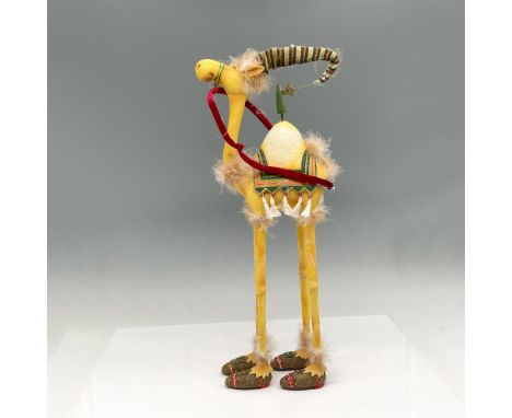 Adorable Yellow camel with colorful blanket, shoes, striped hat and red rein. Department 56 tag. This item has its original b