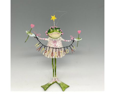 This happy frog is created in pastel colors carrying a banner and 2 hearts in each hand with a gold star on the head. Departm