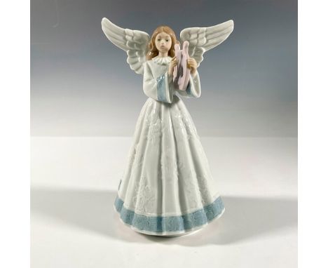 A female angel with white gown and blue trim plays a purple harp. Glossy finish. Lladro backstamp. This item has its original
