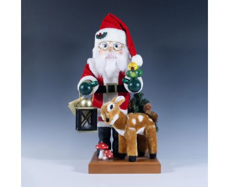 Handmade, hand painted Santa in red suit and hat carrying tea light lantern with his reindeer close by. Green mittened hands 