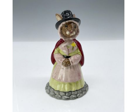 Light pink and yellow dress, red cape, and black hat. Royal Doulton backstamp. Produced exclusively for UK International Cera