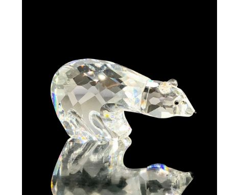 A clear crystal polar bear with diamond shaped cuts throughout its body with black crystal used for the eyes and snout. Swaro