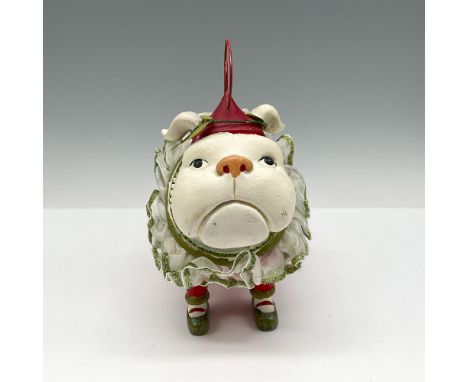 Adorable figure in red polka dot pajamas with green glitter collar wearing a hat with holly. Department 56 mark. This item ha