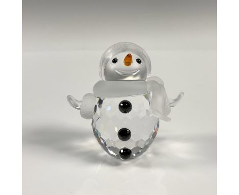 Whimsical faceted crystal figurine modeled as a smiling snowman with his arms wide. Black buttons, orange nose. Satin crystal
