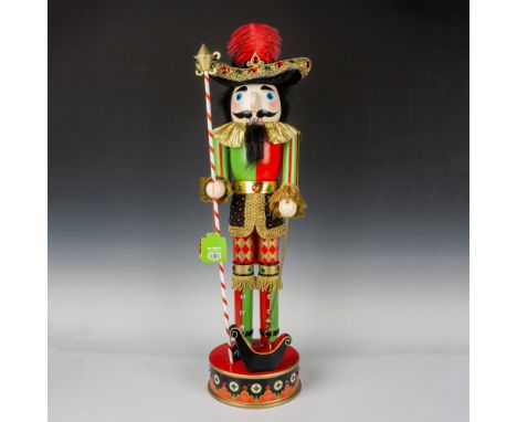 A nutcracker, dressed as a gallant soldier in vibrant red, green, and black attire, wielding a spear atop a matching base. Pi
