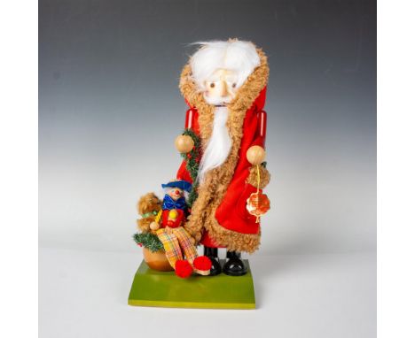Handcrafted and hand painted Christmas figure of Saint Nicholas with a sack full of toys and a pocket full of holly. Steinbac