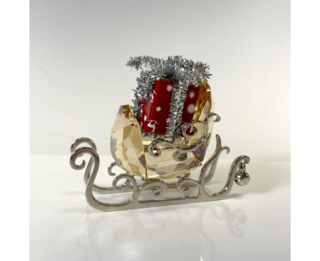 Beautifully crafted in Golden Shadow crystal on a filigree silver-tone metal base with gift wrapped in red paper and silver r
