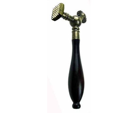 A copper alloy pastry jigger of unusual design, having a cutting wheel and single square print, on turned ebonised hardwood h