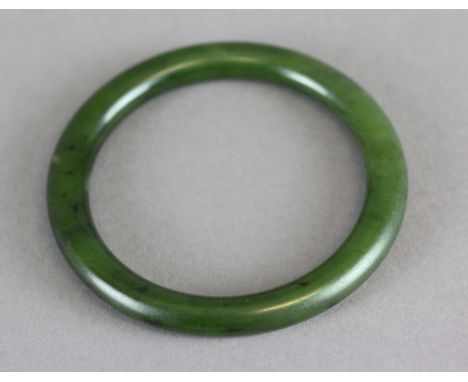 A Chinese jade bangle. 7.7cm(d) 40grams. In good condition.