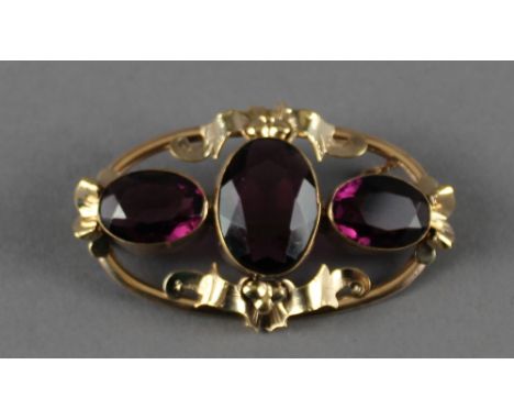 A Victorian pinchbeck and amethyst brooch. 6cm; sold together with an oval porcelain portrait brooch, gilt metal mount.  5.5c