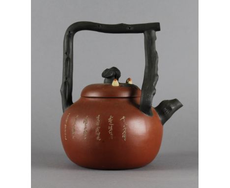 An Yixing rustic-style teapot with loop 'branch' handle and extensive inscription. 21cm high (maker's mark to base - Chinese 