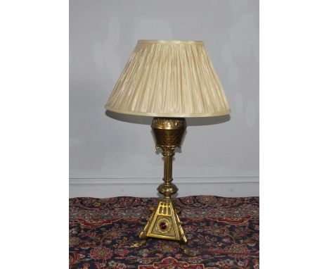 A Victorian lacquered brass table oil lamp, of Gothic revival design, later electric conversion and shade. 63cm to fitting. R