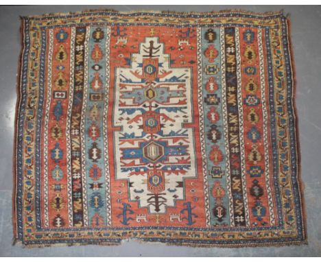 An antique Kazak carpet, 208cm x 195cm With slight damage and wear